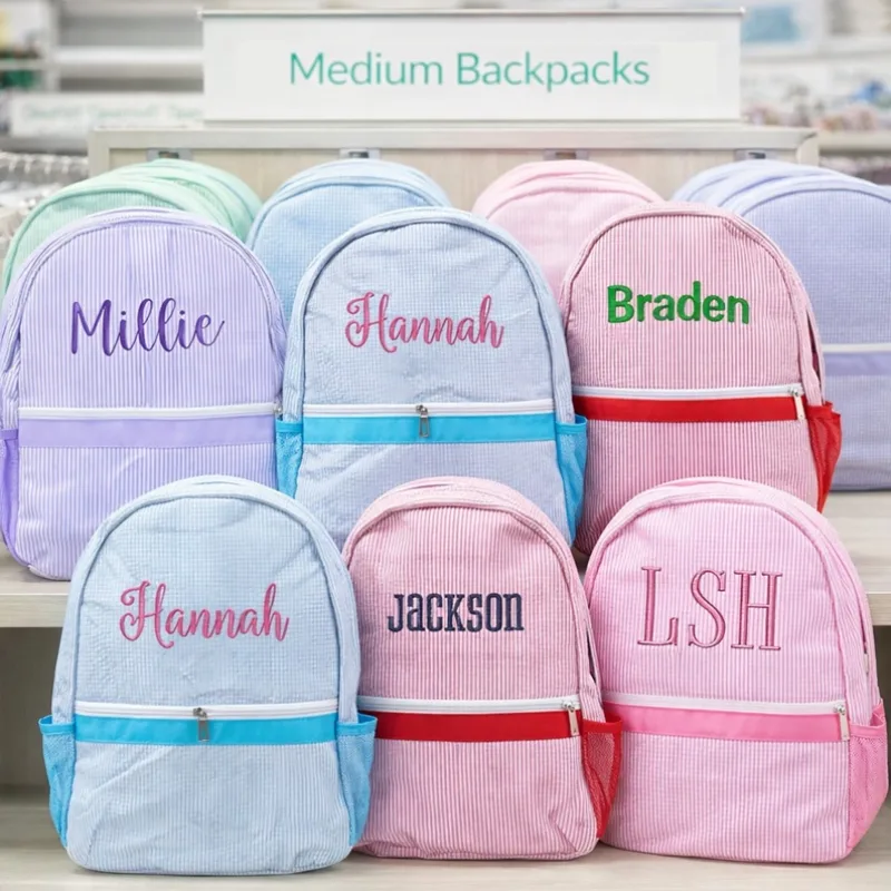 The merchant's original product photo of a personalized seersucker kids backpack
